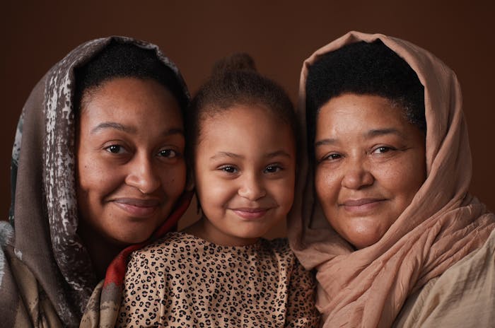Three generations of a family wearing headscarves